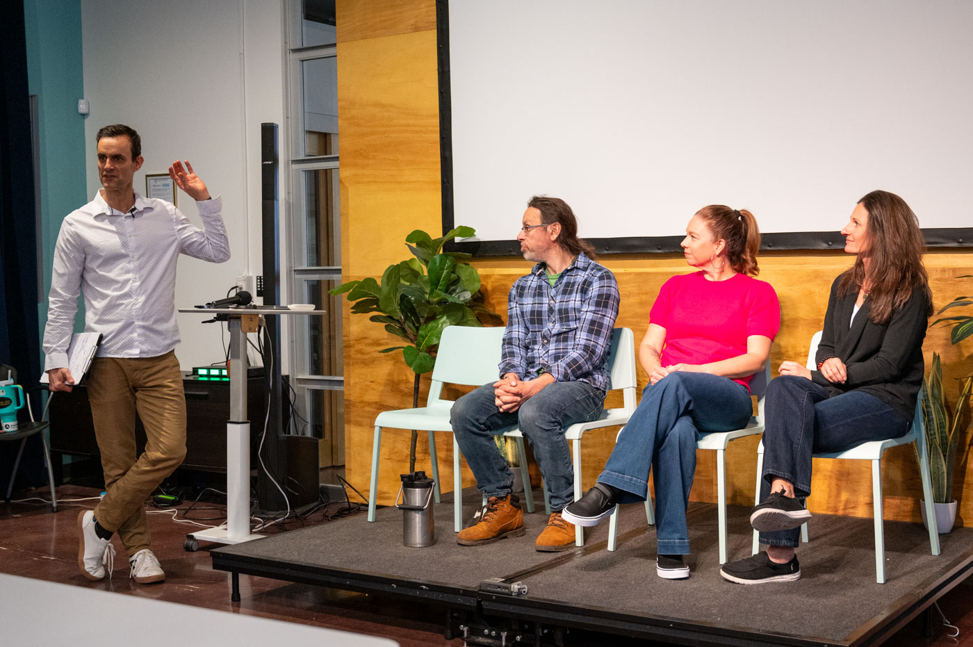 Speaker on stage addressing an engaged audience